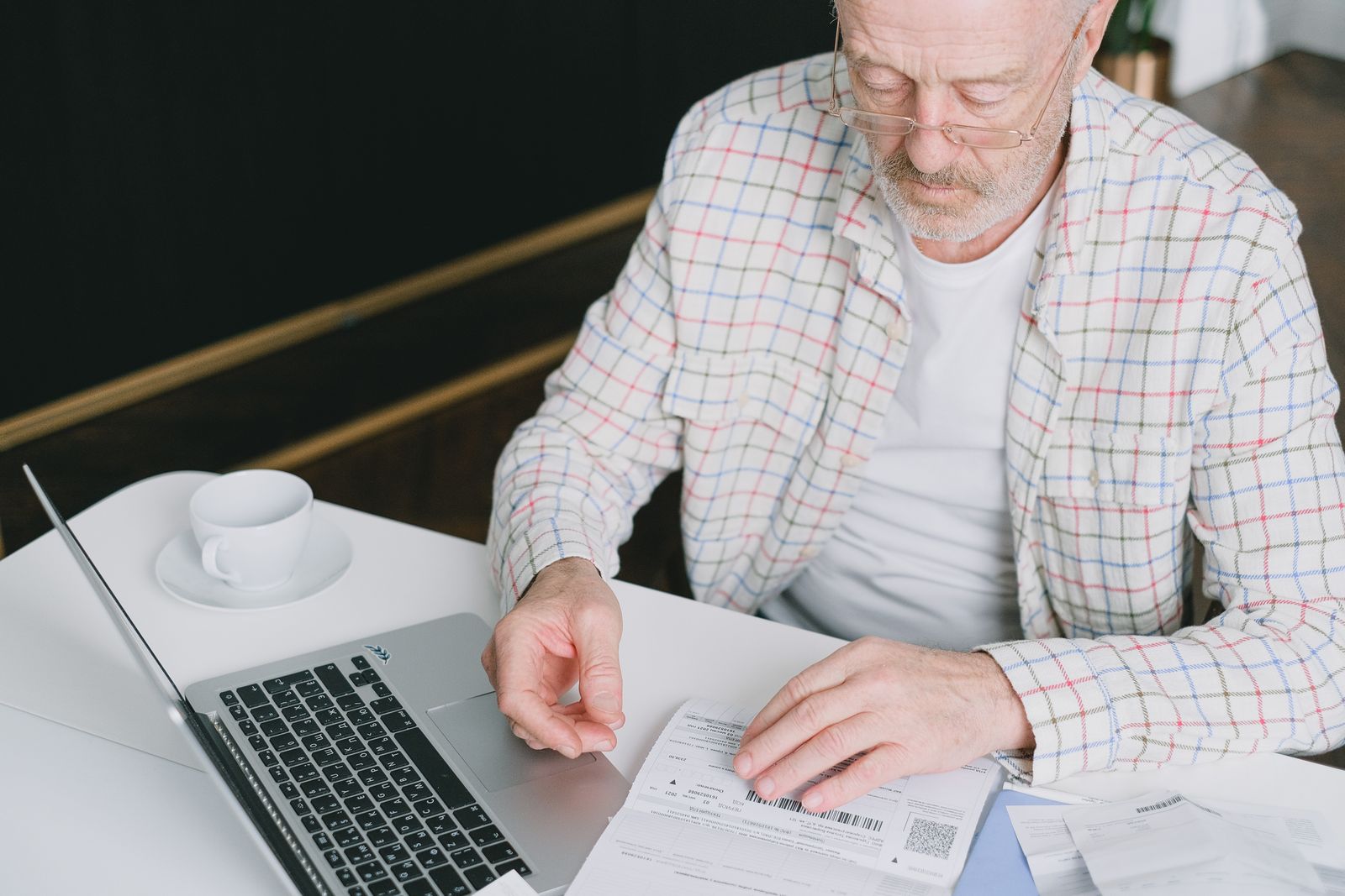 Reading an insurance policy at a kitchen table